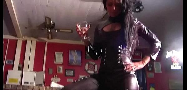  Femdom Amateur Girl in Latex Catsuit and Boots dominate a man in a Bar